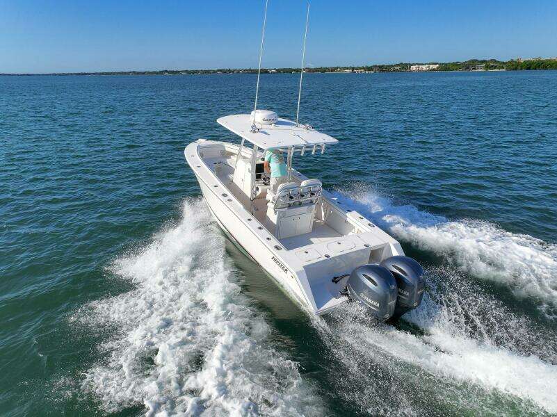 2018 Jupiter 26 FS boat cruising on open water with twin engines.