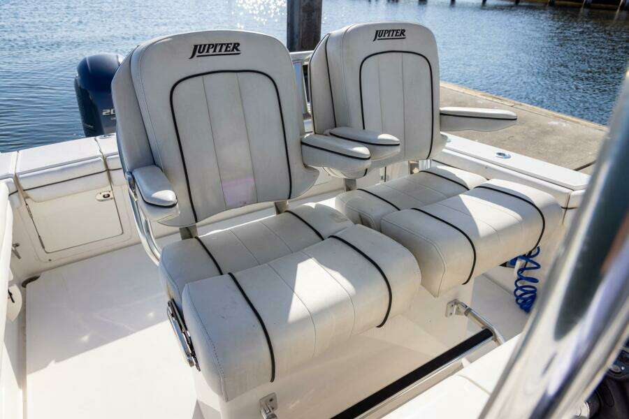 2018 Jupiter 26 FS boat seats, white with black trim, docked by the water.