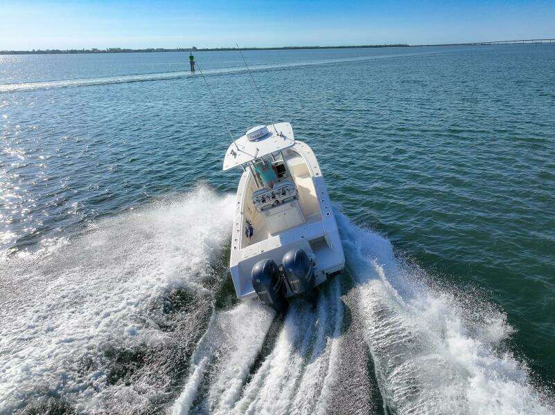 2018 Jupiter 26 FS boat cruising on open water, creating a dynamic wake.