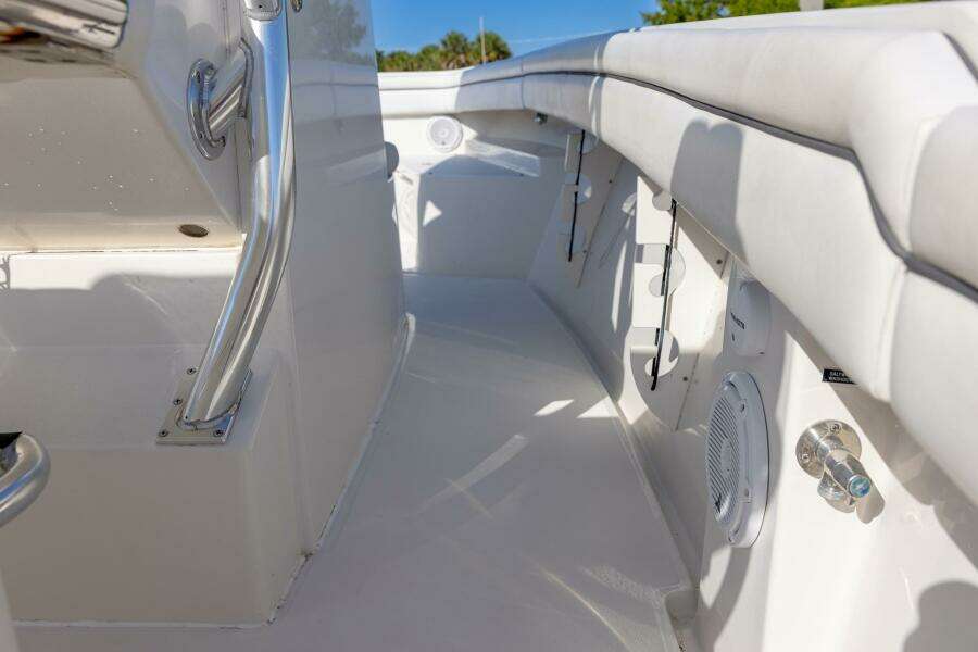 Interior view of a 2018 Jupiter 26 FS boat, featuring sleek white seating and stainless steel fixtures.