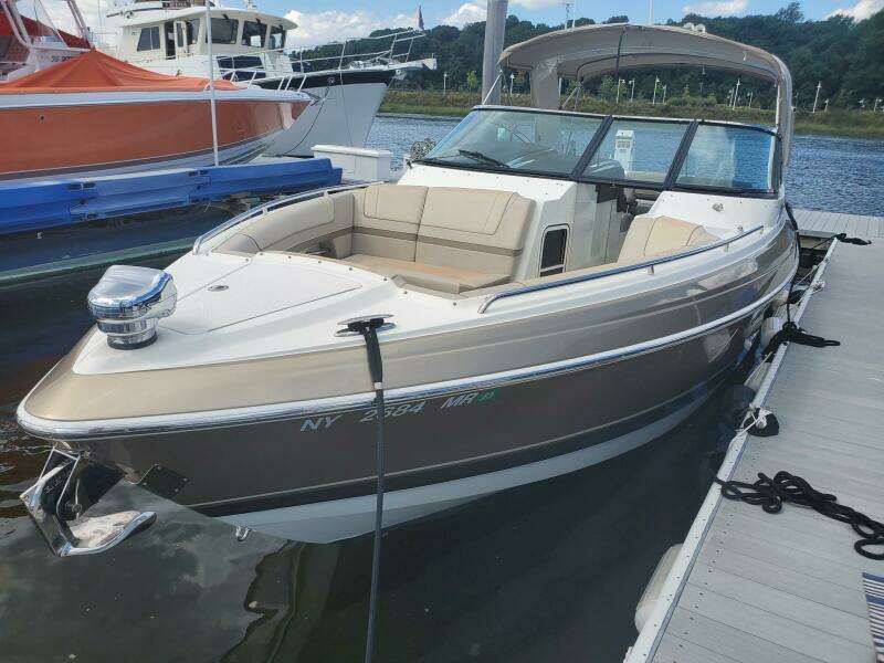 2015 Formula 330 Crossover Bowrider docked, featuring sleek design and spacious seating.