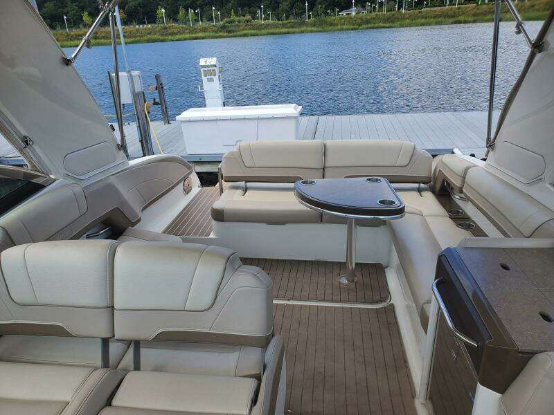2015 Formula 330 Crossover Bowrider interior with seating and table by the water.