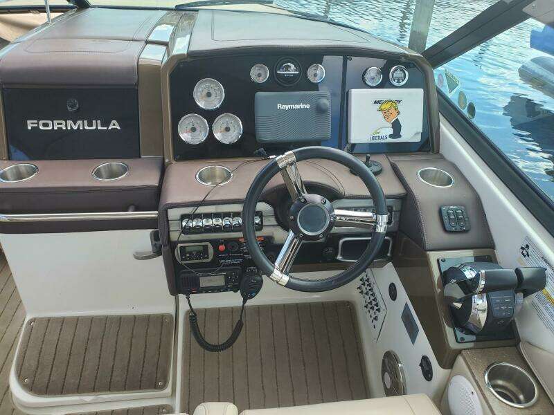2015 Formula 330 Crossover Bowrider dashboard with steering wheel and navigation controls.
