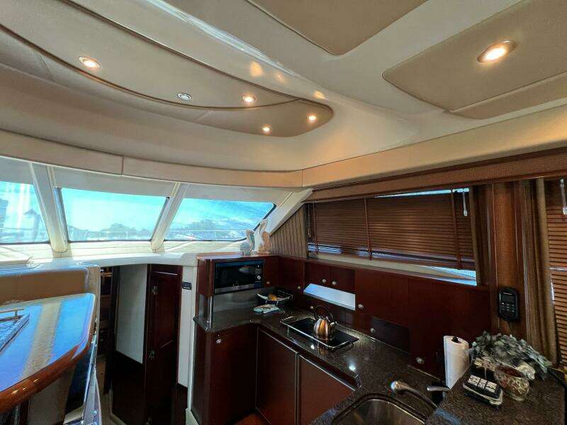 Interior of 2005 Sea Ray 500 Sedan Bridge yacht, featuring a modern kitchen area.