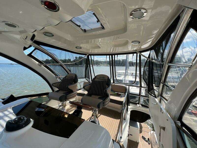 Interior of 2005 Sea Ray 500 Sedan Bridge yacht with panoramic windows and luxurious seating.