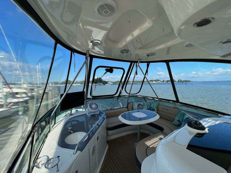 Interior view of 2005 Sea Ray 500 Sedan Bridge yacht with seating and navigation equipment.