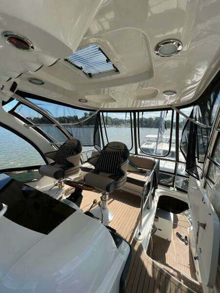 2005 Sea Ray 500 Sedan Bridge interior with seating, panoramic windows, and sleek design.
