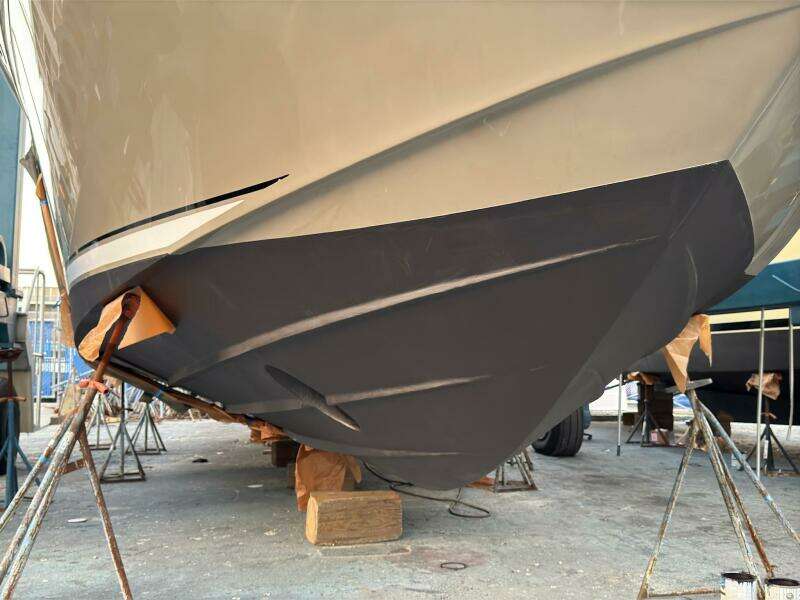 2005 Sea Ray 500 Sedan Bridge boat hull on dry dock for maintenance.