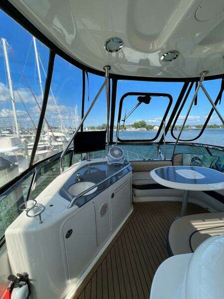 Interior of 2005 Sea Ray 500 Sedan Bridge yacht with seating and marina view.