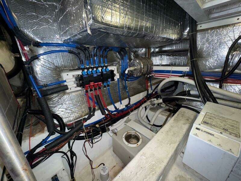 Engine room of a 2000 Carver 506 Motor Yacht with wiring and insulation.