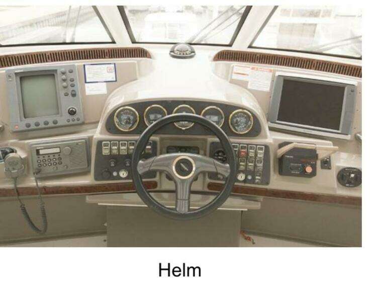 Helm of 2000 Carver 506 Motor Yacht with navigation instruments and steering wheel.