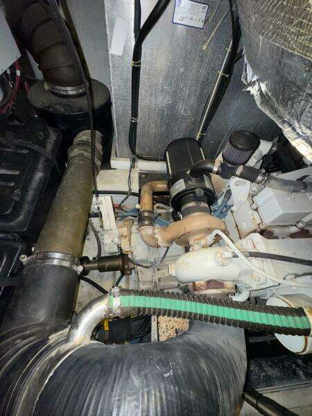 Engine room of a 2000 Carver 506 Motor Yacht, showcasing mechanical components and piping.