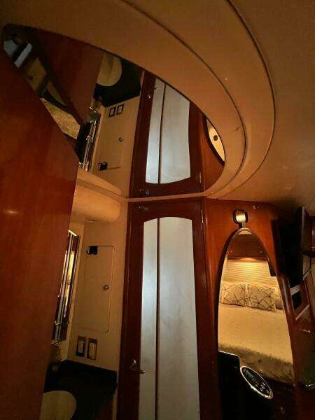 Interior of 2000 Carver 506 Motor Yacht with wood paneling and cozy bedroom.