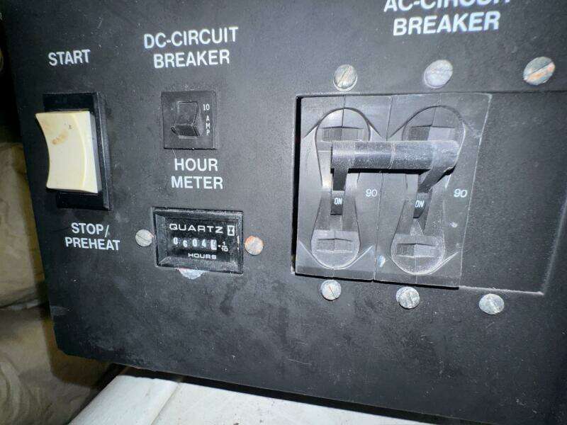 Control panel of a 2000 Carver 506 Motor Yacht with hour meter and circuit breakers.