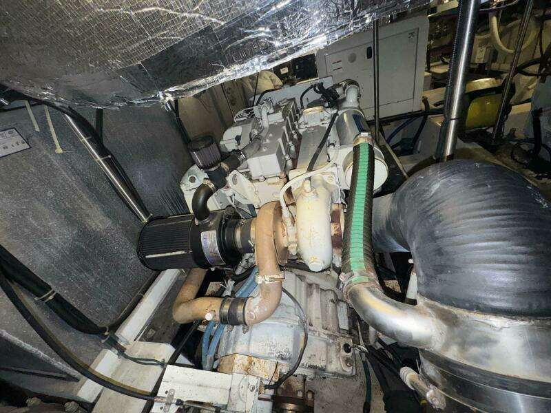 Engine room of 2000 Carver 506 Motor Yacht, showcasing mechanical components and piping.