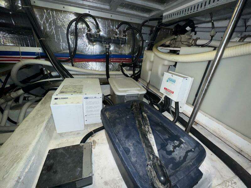 Engine room of 2000 Carver 506 Motor Yacht with various equipment and wiring.