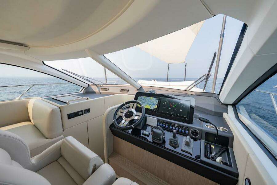 Luxurious 2023 Azimut Fly 53 yacht cockpit with modern navigation system and ocean view.