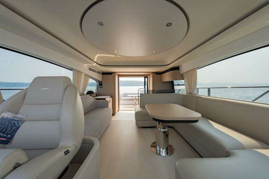 Luxurious interior of 2023 Azimut Fly 53 yacht with elegant seating and panoramic windows.