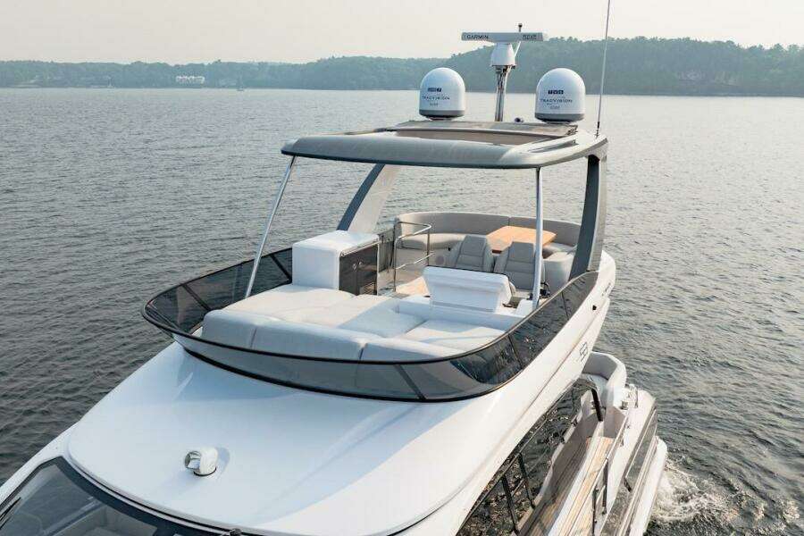 2023 Azimut Fly 53 yacht cruising on a serene lake.