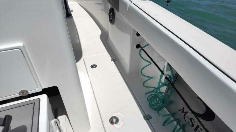 2023 CG Boat Works 35 M-Series deck with coiled hose and storage compartments.