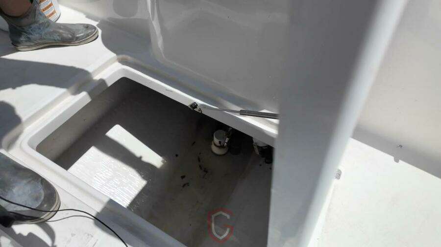 Open compartment on 2023 CG Boat Works 35 M-Series deck, showing interior details.