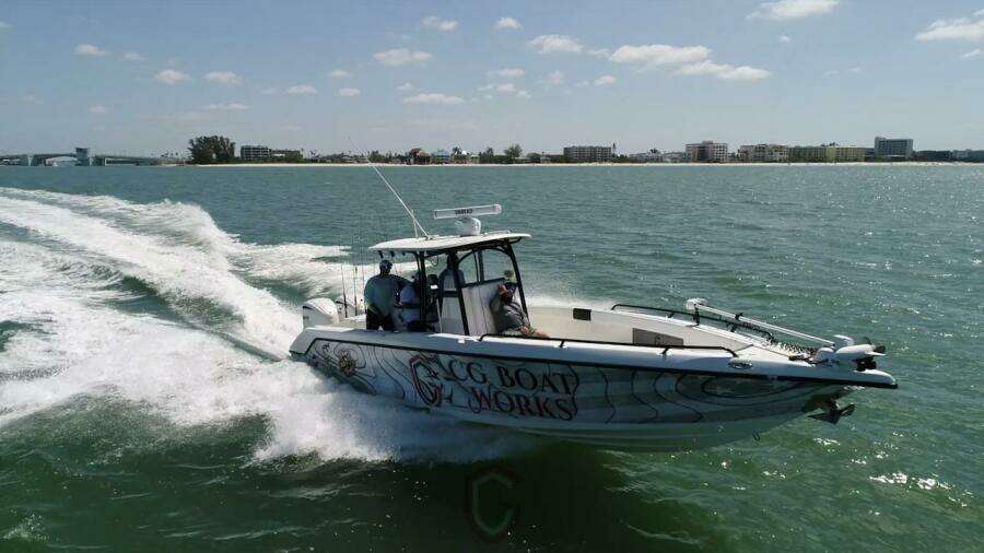 2023 CG Boat Works 35 M-Series cruising on open water near coastline.