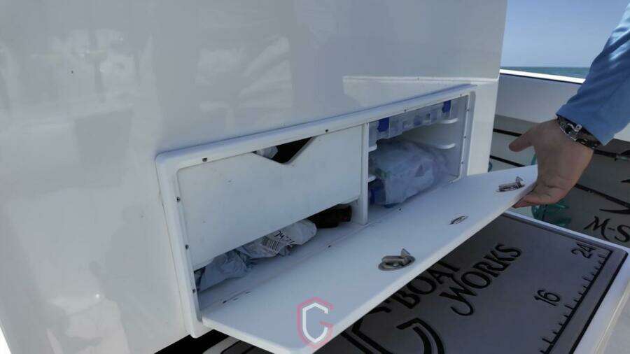 Storage compartment on 2023 CG Boat Works 35 M-Series, open with visible contents.