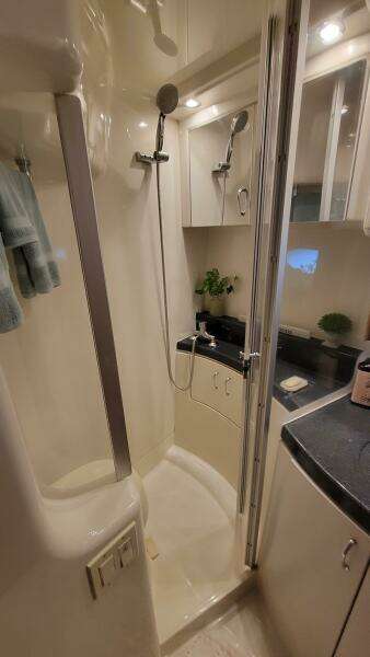 2004 Carver 360 Sport Sedan bathroom with shower, modern fixtures, and sleek cabinetry.