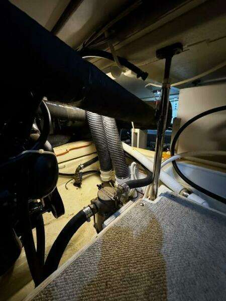 Engine room of a 2004 Carver 360 Sport Sedan with visible hoses and components.