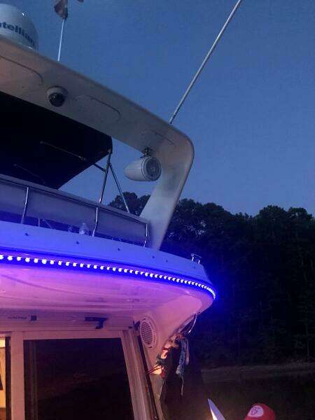 2004 Carver 360 Sport Sedan with blue LED lights at dusk.