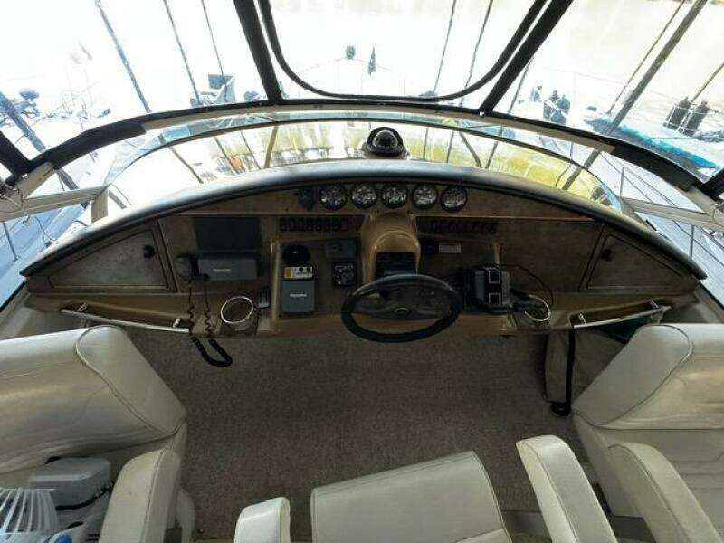 2004 Carver 360 Sport Sedan helm with steering wheel, gauges, and controls.
