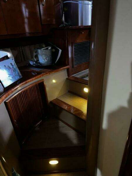 Interior of 2004 Carver 360 Sport Sedan with wooden stairs and ambient lighting.