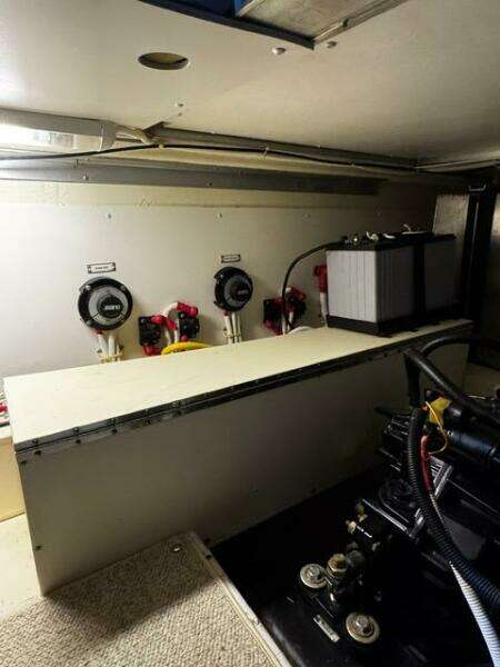 Engine room of a 2004 Carver 360 Sport Sedan with battery and control panels.