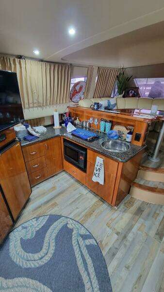 Interior of 2004 Carver 360 Sport Sedan with modern kitchen and cozy seating area.