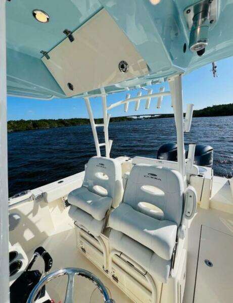 2021 Cobia 301 Center Console boat interior with seating, on a sunny day at sea.