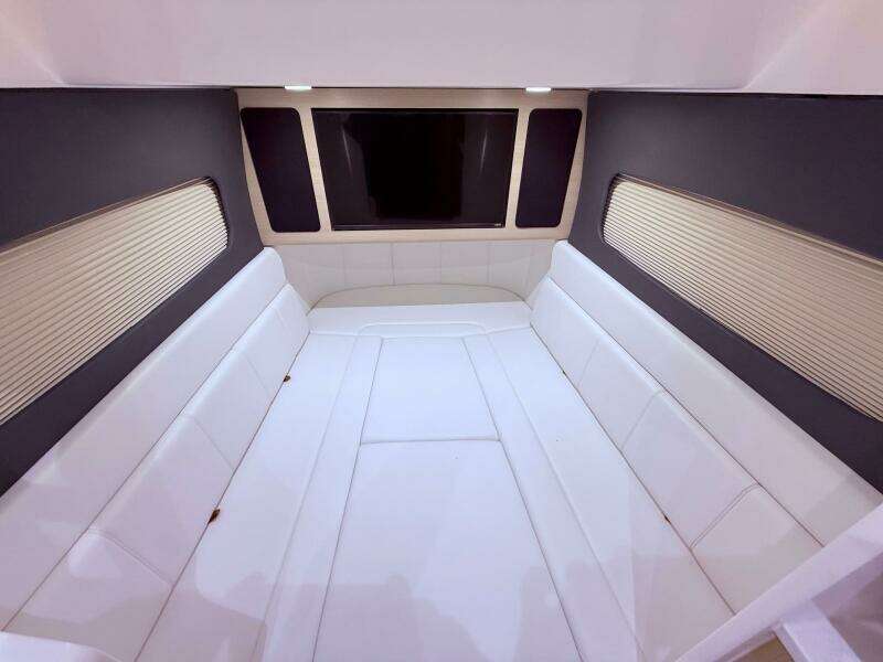 Luxurious interior cabin of 2024 Scout 400 LXF boat with white seating.