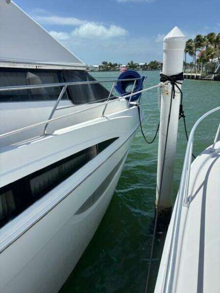 2006 Carver 43 Motor Yacht docked, sunny day, calm waters, blue sky.