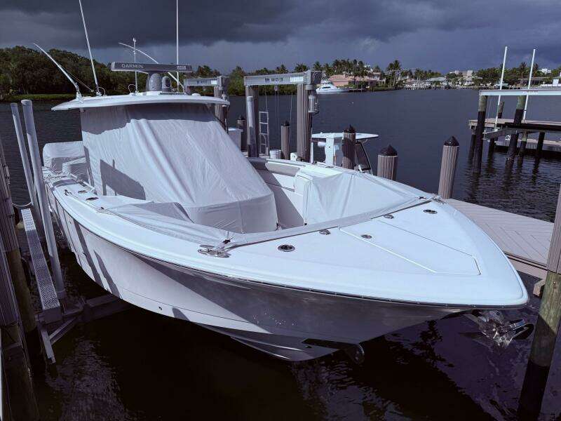 2024 Scout 400 LXF boat docked under cloudy skies.