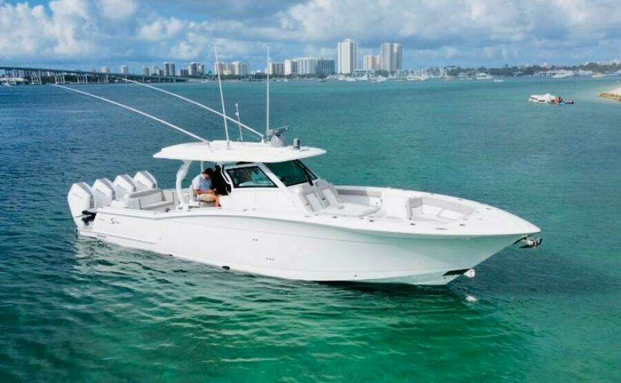 2024 Scout 400 LXF luxury boat cruising in clear turquoise waters.