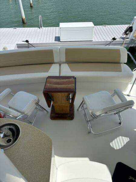 2006 Carver 43 Motor Yacht interior with seating and table, docked by the water.