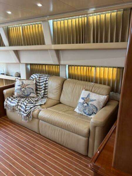 Luxurious interior of 2006 Carver 43 Motor Yacht with leather sofa and decorative pillows.