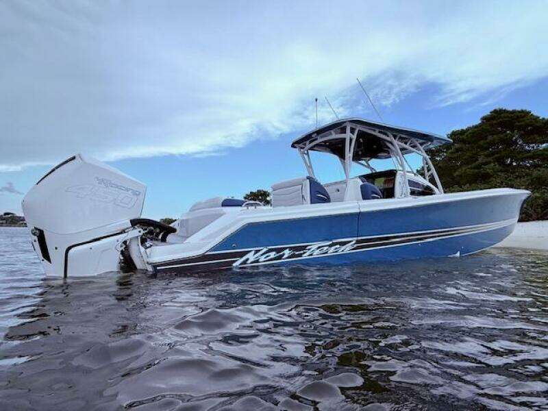 2022 Nor-Tech 390 Sport Center Console boat in water, showcasing sleek design and powerful engine.