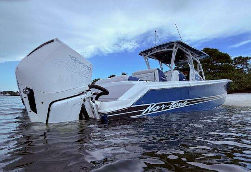 2022 Nor-Tech 390 Sport Center Console boat in water, showcasing sleek design and powerful engine.