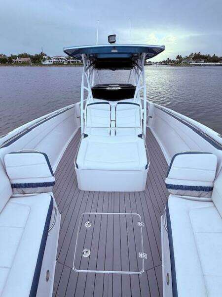 2022 Nor-Tech 390 Sport Center Console boat with spacious seating on calm water.