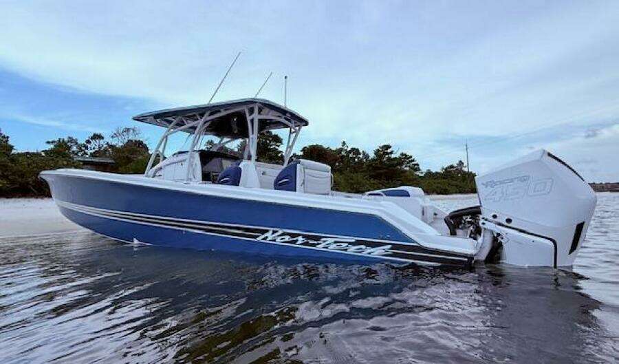 2022 Nor-Tech 390 Sport Center Console boat in water, side view, blue and white design.