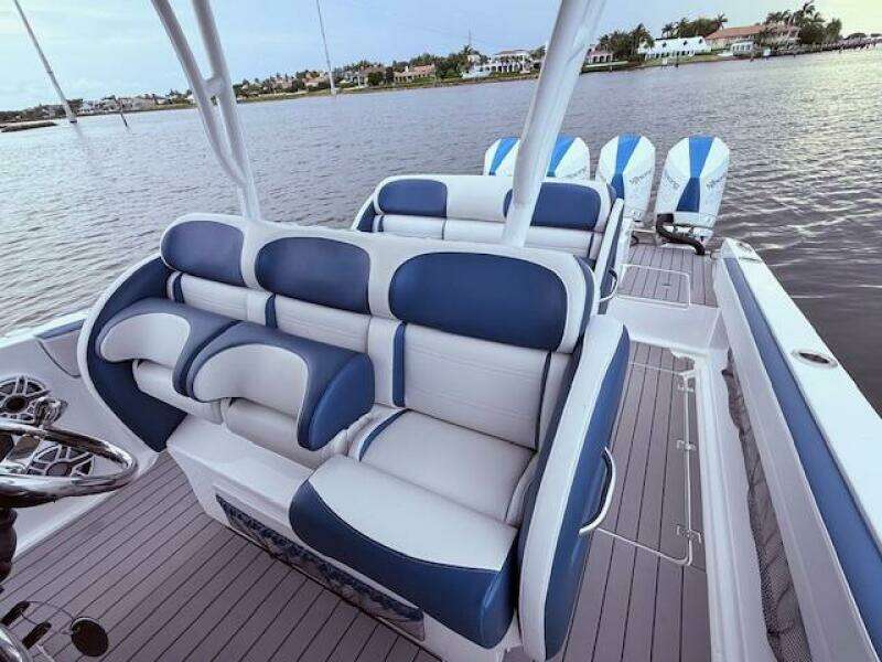 2022 Nor-Tech 390 Sport Center Console boat with blue and white seating on calm water.