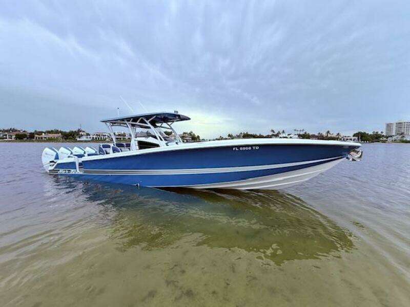 2022 Nor-Tech 390 Sport Center Console boat on calm water, showcasing sleek blue design.