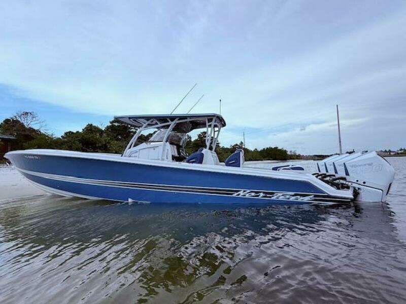2022 Nor-Tech 390 Sport Center Console boat in shallow water, side view.