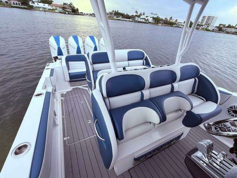 2022 Nor-Tech 390 Sport Center Console boat with luxurious seating on calm water.