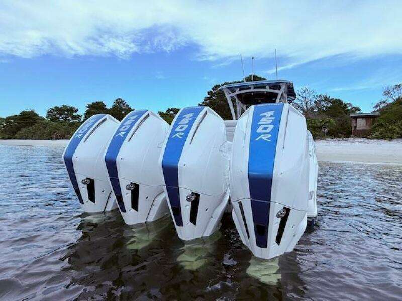 2022 Nor-Tech 390 Sport Center Console with triple 450R engines in shallow water.